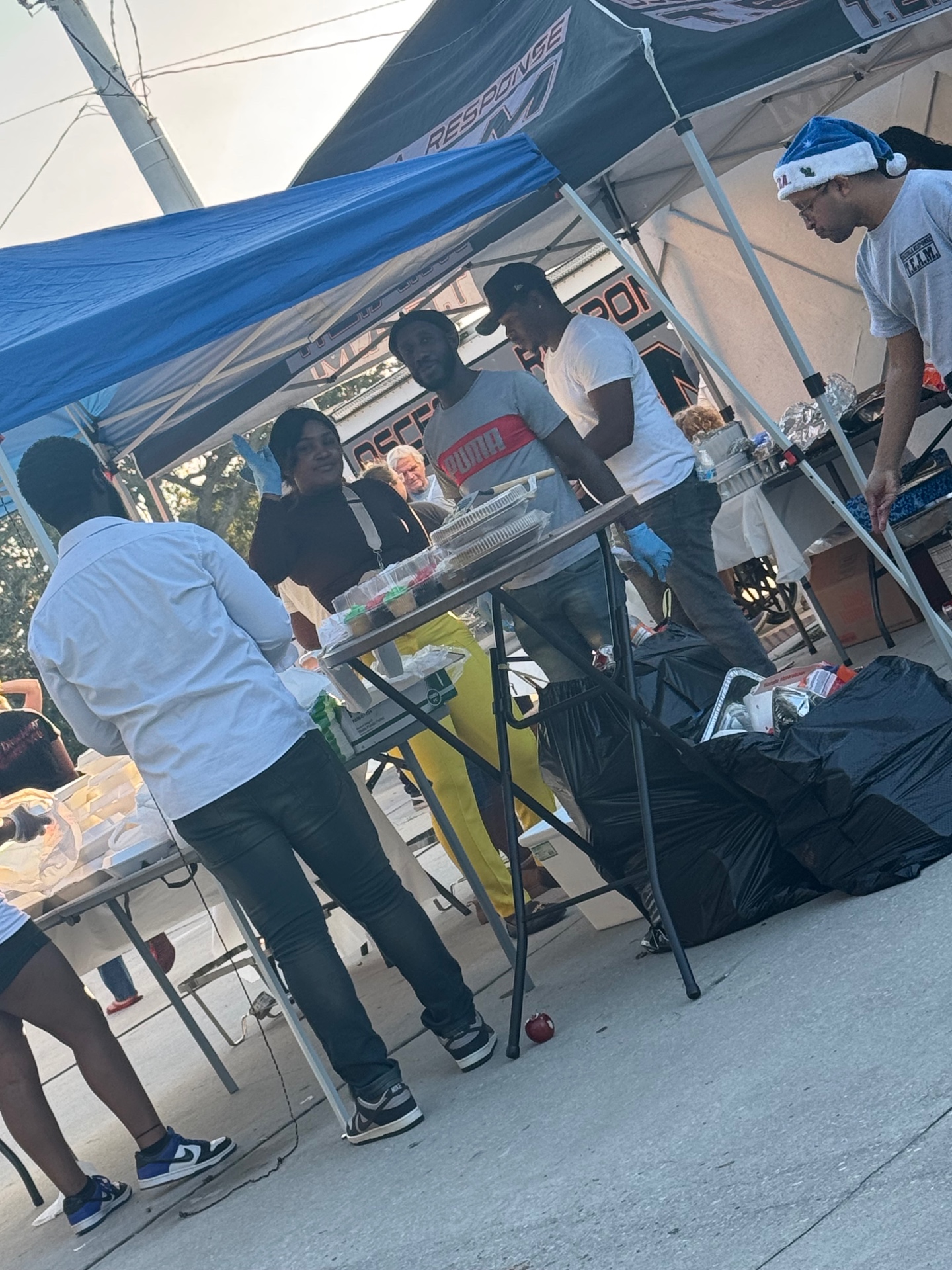 Volunteers handing out food and desserts to guests at the Christmas 2025 community meal